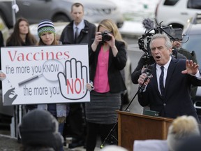 Robert Kennedy Jr., right, speaks at a rally held in opposition to a proposed bill that would remove parents' ability to claim a philosophical exemption to opt their school-age children out of the combined measles, mumps and rubella vaccine, Friday, Feb. 8, 2019, at the Capitol in Olympia, Wash. Amid a measles outbreak that has sickened people in Washington state and Oregon, lawmakers earlier Friday heard public testimony on the bill.