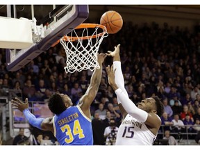 Washington forward Noah Dickerson (15) shoots against UCLA guard David Singleton (34) during the first half of an NCAA college basketball game, Saturday, Feb. 2, 2019, in Seattle.