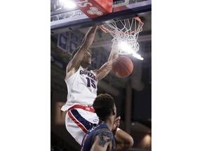 Gonzaga forward Brandon Clarke (15) dunks in front of Pepperdine guard Jade' Smith during the second half of an NCAA college basketball game in Spokane, Wash., Thursday, Feb. 21, 2019.