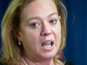 An emotional MPP Lisa MacLeod talks to the media as parents protest outside her constituency office in Barrhaven claiming that the recent funding announcement for autistic children is not nearly enough.