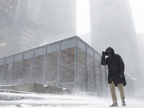 A pedestrian braves the blowing snow as a storm front moved in Toronto Monday, January 28, 2019.