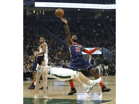 Washington Wizards' Jeff Green (32) commits an offensive foul on Milwaukee Bucks' Ersan Ilyasova during the first half of an NBA basketball game Wednesday, Feb. 6, 2019, in Milwaukee.