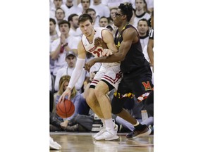 Wisconsin's Ethan Happ (22) drives on Maryland's Jalen Smith during the first half of an NCAA college basketball game Friday, Feb. 1, 2019, in Madison, Wis.