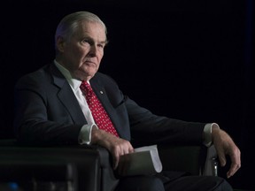 Michael Wilson, former federal minister of finance, sits on stage during the launch of the alternative stock exchange Aequitas NEO Exchange in Toronto on Friday, March 27, 2015.