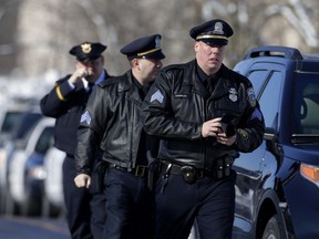 Milwaukee police officers arrive with the public at Oak Creek Assembly of God Church for the public visitation for slain Milwaukee Police Officer Matthew Rittner, Wednesday, Feb. 13, 2019, in suburban Milwaukee. Rittner was killed while serving a search warrant a week ago. Rittner was a U.S. Marine veteran who served two tours in Iraq.