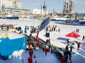 A canoe is lifted by a crane after the Quebec Winter Carnival’s annual ice canoe race in Quebec City on Feb. 10, 2019.