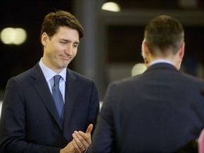 Winnipeg mayor Brian Bowman finishes speaking as Prime Minister Justin Trudeau looks on at a transit funding announcement at the Winnipeg Transit bus barn, Tuesday, February 12, 2019.