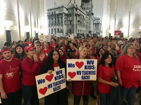 Striking West Virginia teachers and supporters rally outside the House of Delegates chambers Tuesday, Feb. 19, 2019, at the state Capitol in Charleston, W.Va. Teachers are opposed to a complex education bill making its way through the Legislature.