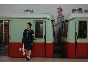 In this Sept. 13, 2018, file photo, a North Korean subway officer stands next to a train in a subway station in Pyongyang, North Korea. At the negotiating table, it can be difficult to get the North Koreans off their scripted talking points.