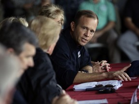 FILE - In this Sept. 19, 2018, file photo, President Donald Trump listens as FEMA Administrator Brock Long, right, speaks while attending a briefing, after arriving at Marine Corps Air Station Cherry Point to visit areas impacted by Hurricane Florence in Havelock, N.C. Long resigned on Feb. 13, 2019.