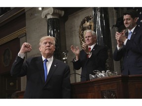 FILE - In this Jan. 30, 2018, file photo, President Donald Trump gestures as he finishes his first State of the Union address in the House chamber of the U.S. Capitol to a joint session of Congress in Washington, as Vice President Mike Pence and House Speaker Paul Ryan applaud.