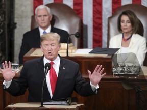 In this Feb. 5, 2019 photo, President Donald Trump delivers his State of the Union address to a joint session of Congress on Capitol Hill in Washington, as Vice President Mike Pence and Speaker of the House Nancy Pelosi, D-Calif., watch. In his State of the Union, President Donald Trump said a "powerful barrier" had cut crime rates and turned El Paso, Texas, from one of the nation's most dangerous cities to one of its safest. But many in El Paso, site of Trump's rally Monday night, say the city was safe for decades and embodies a cross-border spirit that transcends walls rather than prove they work.