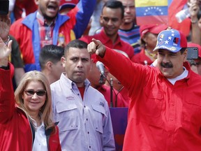 President Nicolas Maduro and first lady Cilia Flores greet supporters as they arrive at a rally in Caracas, Venezuela, Saturday, Feb. 2, 2019. Maduro called the rally to celebrate the 20th anniversary of the late President Hugo Chavez's rise to power.