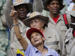 Supporters of President Nicolas Maduro sing a song about Venezuela's late president Hugo Chavez, during a event at Bolivar Square in Caracas, Venezuela, Thursday, Feb. 7, 2019.  Maduro said that he hopes to collect 10 million signatures to ask Washington to withdraw its threats of war against the people of Venezuela.