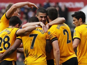 Wolverhampton players celebrate after Ivan Cavaleiro, center left, scored the opening goal during the English FA Cup fifth round soccer match between Bristol City and Wolverhampton Wanderers at Ashton Gate stadium in Bristol, England, Sunday, Feb. 17, 2019.