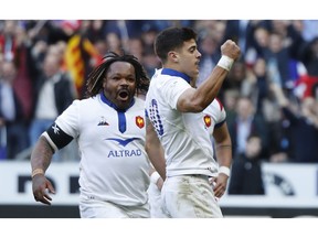 Mathieu Bastareaud of France, left, goes to celebrate with Romain Ntamack of France who scored the opening try of the game during the Six Nations rugby union international match between France and Scotland at the Stade de France in Paris, Saturday, Feb. 23, 2019.