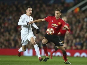 Manchester United's Nemanja Matic, right vies for the ball with Paris Saint Germain's Julian Draxler during the Champions League round of 16 soccer match between Manchester United and Paris Saint Germain at Old Trafford stadium in Manchester, England, Tuesday, Feb. 12, 2019.