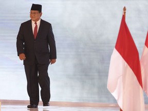 Indonesian presidential candidate Prabowo Subianto walks during a televised debate in Jakarta, Indonesia, Sunday, Feb. 17, 2019. Indonesia is gearing up to hold its presidential election on April 17 that will pit in the incumbent against the former general.