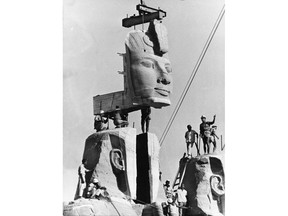 FILE - In this photo taken on Oct. 11, 1966 in Egypt, workmen lower one of the heads of the four rock-hewn colossi of King Ramses II into place, on the foundation of the re-sited monument. The global campaign that saved the ancient Egyptian temples of Abu Simbel from inundation by the Aswan Dam 50 years ago was remembered this week as an unprecedented engineering achievement and a turning point in the perception of cultural treasures as a responsibility of all humanity. (AP Photo)
