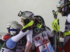 The Swiss team celebrates winning the gold medal in the finish area during the team event, at the alpine ski World Championships in Are, Sweden, Tuesday, Feb. 12, 2019.