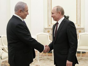 Russian President Vladimir Putin, right, shakes hands with Israeli Prime Minister Benjamin Netanyahu during their meeting in the Kremlin in Moscow, Russia, Wednesday, Feb. 27, 2019. The talks are expected to focus on the situation in Syria.