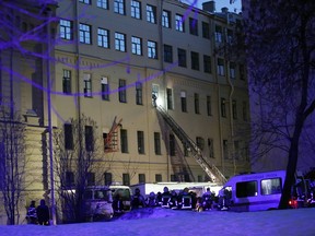 Russian Emergency employees work at the scene of the collapse building of the Saint Petersburg National Research University of Information Technologies, Mechanics and Optics in St. Petersburg, Russia, Saturday, Feb. 16, 2019. Russian emergency authorities say several floors of a university building in Russia's second-largest city have collapsed. There was no immediate information on casualties.
