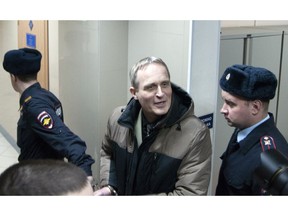 In this handout photo released by Courtesy of Jehovah's Witnesses, Dennis Christensen, who was leading the local Bible reading, is escorted from a court room in Oryol, Russia, Wednesday, Feb. 6, 2019. A regional court in western Russia on Wednesday sentenced a Danish Jehovah's Witness to six years in prison, in arguably the most severe crackdown on religious freedom in Russia in recent years. .
