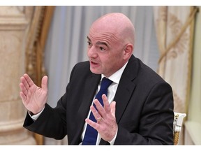 FIFA President Gianni Infantino gestures while speaking to Russian President Vladimir Putin in the Kremlin in Moscow, Russia, Wednesday, Feb. 20, 2019.