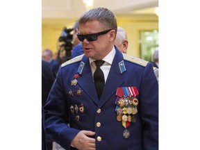 In this photo taken on Thursday, Feb. 14, 2019, Vladimir Vshivtsev, a veteran of the Soviet war in Afghanistan attends a meeting at the upper chamber of Russian parliament in Moscow, Russia. Vshivtsev, who was wounded in action and lost his eye-sight, became a leading activist in the Russian Society for the Blind and served a stint in the Russian parliament.