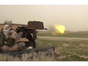 This frame grab from video posted online Jan. 18, 2019, by supporters of the Islamic State group, purports to show a gun-mounted IS vehicle firing at members of the U.S.-backed Syrian Democratic Forces, in the eastern Syrian province of Deir el-Zour, Syria. As they cling to the tiny remains of what was once a self-styled caliphate spanning two countries, IS militants are laying the groundwork for an insurgency. Activists say they are carrying out targeted assassinations, setting up flying checkpoints and distributing fliers to intimidate residents. They fear the group could stage an even bigger comeback if U.S. forces withdraw from Syria. (Militant Photo via AP)