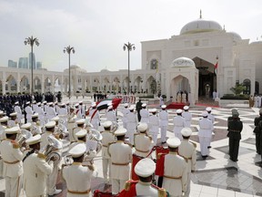 Pope Francis, stands at the palace entrance, flanked by Crown Prince Sheikh Mohammed bin Zayed Al Nahyan, right, and Sheikh Mohammed bin Rashid al Maktoum, left, on the occasion of an official welcome ceremony at the Presidential Palace, in Abu Dhabi, United Arab Emirates, Monday, Feb. 4, 2019. Francis has arrived at the presidential palace to officially start his historic visit to the United Arab Emirates as canons boomed and a military aircraft flew over trailing the yellow and white smoke of the Holy See flag.