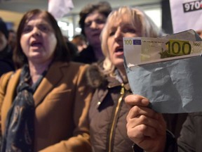 Wives shout slogans during a protest against President Milo Djukanovic in Montenegro's capital Podgorica, Saturday, Feb. 16, 2019. Several thousand people have rallied in Montenegro demanding the resignation of long-serving President Milo Djukanovic's government over allegations of corruption. The crowd has marched through the capital of Podgorica chanting "Milo thief" and carrying banners reading "No more crime" or "Rebellion."