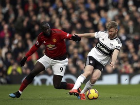 Manchester United's Romelu Lukaku, left, duels for the ball with Fulham's Tim Ream during the English Premier League soccer match between Fulham and Manchester United at Craven Cottage stadium in London, Saturday, Feb. 9, 2019.