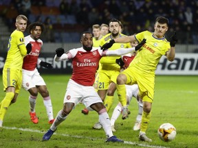 Arsenal's Alexandre Lacazette, front center, duels for the ball with Bate's Stanislav Dragun during the Europa League round of 32 first leg soccer match between Bate and Arsenal at the Borisov-Arena in Borisov, Belarus, Thursday, Feb. 14, 2019.