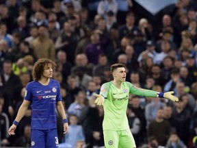 Chelsea goalkeeper Kepa Arrizabalaga, right, and Chelsea's David Luiz react during the English League Cup final soccer match between Chelsea and Manchester City at Wembley stadium in London, England, Sunday, Feb. 24, 2019.