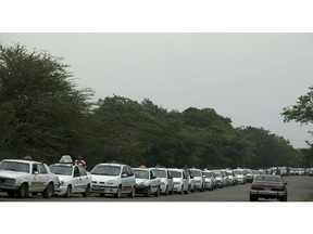 Taxi-cabs lineup to fill up on fuel near San Antonio, Venezuela, Thursday, Feb. 21, 2019. The vehicles queue for almost 2 kilometers from the gas station, as fuel sales are restricted to a couple of days per week in an attempt to control smuggling into Colombia.