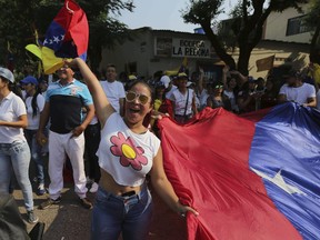 A woman shouts slogans against Venezuela's President Nicolas Maduro during a protest against his government in Urena, Venezuela, Tuesday, Feb. 12, 2019. Nearly three weeks after the Trump administration backed an all-out effort to force out President Nicolas Maduro, the embattled socialist leader is holding strong and defying predictions of an imminent demise.