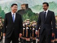 Chinese President Xi Jinping, left, and Qatar's Emir Tamim bin Hamad al-Thani  review a military honour guard in Beijing's Great Hall of the People on Jan. 31, 2019.