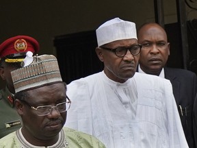 Incumbent President Muhammadu Buhari, center, leaves his party's headquarters after holding an emergency meeting with senior members of the All Progressives Congress (APC) in Abuja, Nigeria, Monday Feb. 18, 2019. Nigeria's electoral commission delayed the presidential election until Feb. 23.