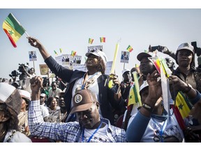 In this photo taken on Thursday, Feb. 21, 2019, supporters of Senegalese President Macky Sall cheer as he speaks at a rally ahead of Sunday's presidential elections in Dakar, Senegal.  Sall is seeking a second term in office and hopes to win re-election Sunday in the first round.