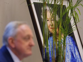 Lord Mayor of the City of London Peter Estlin speaks in front of the portrait of the Britain's Queen Elizabeth II during a news conference in Hong Kong, Tuesday, Feb. 19, 2019. Estlin paid an official visit to Hong Kong from Feb. 18 to 19 to reinforce the UK's links with cities across Asia.