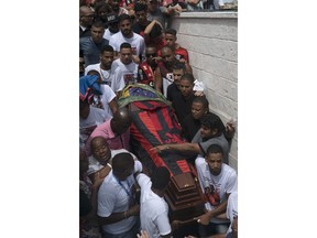 Friends and relatives carry the coffin that contain the remains of Samuel de Souza Rosa, one of the 10 young soccer players killed in a fire at the training ground of Brazilian soccer club Flamengo, during his funeral in Sao Joao de Meriti, Brazil, Monday, Feb. 11, 2019. The death of de Souza Rosa and his teammates has shed a tragic light on the state of shoddy infrastructure and lax oversight in Latin America's largest nation.