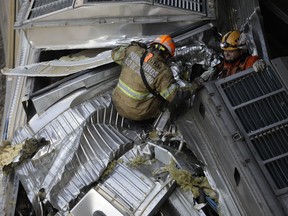 Firefighters work on the wreckage of two commuter trains that collided in Sao Cristovao station, in Rio de Janeiro, Brazil, Wednesday, Feb. 27, 2019. The Rio fire department says eight injured people were brought to hospitals while the driver remains trapped in the wreckage, with about a dozen firefighters working on a rescue.