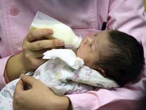 In this Jan. 19, 2019, photo, a nurse feeds a newborn baby at a hospital in Fuyang in central China's Anhui province. Facing a future demographic crisis and aging society, China's leaders are desperate to encourage higher fertility rates. But the country's bureaucrats don't seem to have gotten the message, fining a couple in a recent widely publicized case for having a third child against the strict letter of the law. That has sparked outrage among the public, who are venting their anger at officials who long persecuted couples for violating the now-scrapped "one-child policy."(Chinatopix via AP)