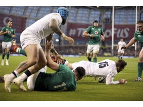 England's Elliot Daly, right, scores England's second try during the Six Nations rugby union international between Ireland and England, in Dublin, Ireland, Saturday, Feb. 2, 2019.