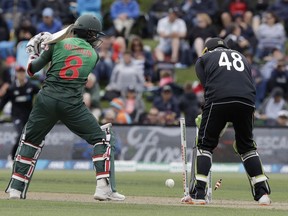 Bangladesh's Mohammad Mithun, left, is out bowled as New Zealand's Tom Latham watches during the one day international cricket match between New Zealand and Bangladesh in Christchurch, New Zealand, Saturday, Feb. 16, 2019.