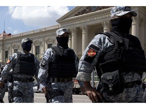 National Police special forces begin a security operation outside the National Palace in preparation for the presidential election, in San Salvador, El Salvador, Saturday, Feb. 2, 2019. Salvadorans elect a new president on Sunday.