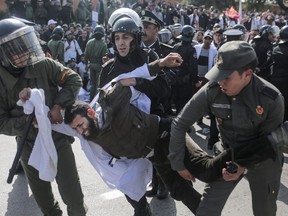 Security forces detain a protesting teacher during a demonstration in Rabat, Morocco, Wednesday, Feb. 20, 2019. Moroccan police fired water cannons at protesting teachers who were marching toward a royal palace and beat people with truncheons amid demonstrations around the capital Wednesday.