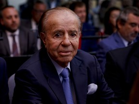 Former Argentine President Carlos Menem sits at a court house in Buenos Aires, Argentina, Thursday, Feb. 28, 2019. The court is expected to give its verdict on the trial against Menem, several former officials, a former federal judge and two former prosecutors, accused of hampering the investigation of the attack on a Jewish center in Buenos Aires in 1994.