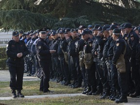 Policemen prepare to secure the Parliament building as opposition supporters gather to participate in an anti-government rally in capital Tirana, Albania, on Tuesday, Feb. 21, 2019. Albania's opposition supporters have surrounded the parliament building Thursday, asking for the resignation of the government which they allege is corrupt.